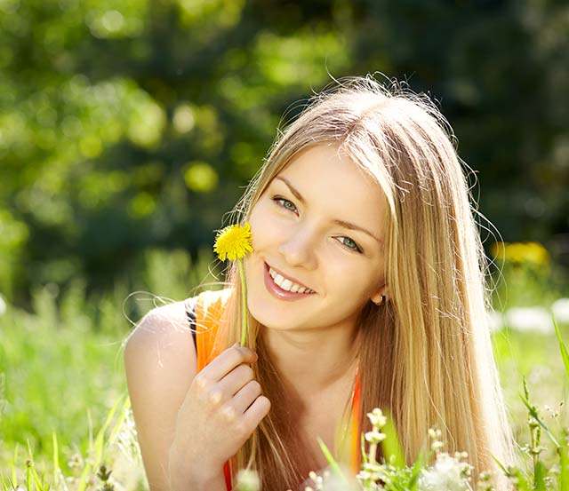 Women in field holding flower