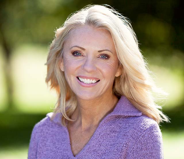 woman in purple shirt with blonde hair